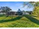 Expansive backyard featuring a screened in patio and lush green lawn at 1249 Mazarion Pl, Trinity, FL 34655