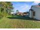 Expansive backyard featuring a screened-in pool, lush landscaping and plenty of space for outdoor activities at 1249 Mazarion Pl, Trinity, FL 34655