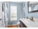 Well-lit bathroom features a vanity with storage, modern faucet, and shower with curtain at 1249 Mazarion Pl, Trinity, FL 34655