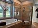 Bathroom featuring a soaking tub, glass enclosed shower, and tile accents at 1249 Mazarion Pl, Trinity, FL 34655