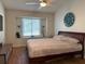 Bright bedroom features a large window, vaulted ceiling, ceiling fan, and wood flooring at 1249 Mazarion Pl, Trinity, FL 34655