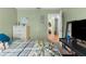 Green-painted bedroom featuring carpet, bed, closet, with a TV and view into the hallway at 1249 Mazarion Pl, Trinity, FL 34655