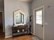 Bright entryway with console table, mirror, coat rack and door with window panels at 1249 Mazarion Pl, Trinity, FL 34655