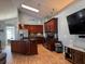Spacious kitchen boasts a large island, wooden cabinets, and stainless steel appliances at 1249 Mazarion Pl, Trinity, FL 34655