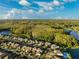 Community overview featuring houses, lakes, and lush greenery at 13022 Payton St, Odessa, FL 33556