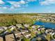 Community overview featuring houses, lakes, and lush greenery at 13022 Payton St, Odessa, FL 33556