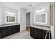 Double vanity bathroom with granite countertops and lighted mirrors at 13022 Payton St, Odessa, FL 33556