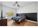 Bedroom with wood-look floors and a black and white comforter set at 13022 Payton St, Odessa, FL 33556