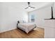 Bedroom with wood-look floors and a gray and white striped comforter at 13022 Payton St, Odessa, FL 33556