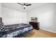 Bedroom with wood-look floors and a black and white comforter set at 13022 Payton St, Odessa, FL 33556