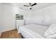 Bedroom with wood-look floors and a gray and white striped comforter at 13022 Payton St, Odessa, FL 33556