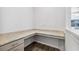 Built-in desk with light beige cabinets and speckled countertop at 13022 Payton St, Odessa, FL 33556