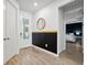 Bright and spacious entryway with wood-look tile floors and a black accent wall at 13022 Payton St, Odessa, FL 33556