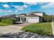 Two-story home with a two-car garage and a landscaped yard at 13022 Payton St, Odessa, FL 33556