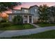 Two-story home with stone accents and a landscaped yard at 13022 Payton St, Odessa, FL 33556