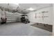 Garage with golf cart, overhead storage, and gym flooring at 13022 Payton St, Odessa, FL 33556