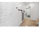 Laundry room with white shiplap walls, barn door, and washer/dryer at 13022 Payton St, Odessa, FL 33556