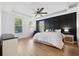 Main bedroom with a large bed and dark accent wall at 13022 Payton St, Odessa, FL 33556