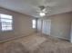 Bedroom with ceiling fan, carpet flooring and double closets at 1304 Greenlea Dr, Holiday, FL 34691