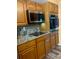 Well-equipped kitchen featuring stainless steel appliances and wood cabinets at 1354 Linstock Dr, Holiday, FL 34690