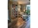 Comfortable living area featuring wood floors, a decorative cabinet, and a relaxing seating area at 1354 Linstock Dr, Holiday, FL 34690