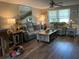Inviting living room featuring wood flooring, plush seating, and a ceiling fan for comfortable living at 1354 Linstock Dr, Holiday, FL 34690