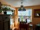 Charming room featuring a stained glass light fixture, ample natural light, and custom woodwork at 1354 Linstock Dr, Holiday, FL 34690