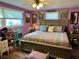 Main bedroom with purple walls, large bed, and lovely decor at 1354 Linstock Dr, Holiday, FL 34690