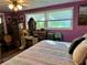 Main bedroom with purple walls, a large bed, and ample closet space at 1354 Linstock Dr, Holiday, FL 34690