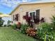 Landscaped side yard with colorful plants at 1354 Linstock Dr, Holiday, FL 34690