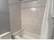 Clean bathroom with a shower/tub combo and tile surround at 140 Hunter Lake Dr # H, Oldsmar, FL 34677