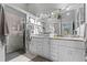 Elegant bathroom with double vanity, granite countertops, and a walk-in shower at 1400 Summerwood Ct, Spring Hill, FL 34606
