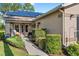 Inviting walkway to front entrance, featuring landscaping and solar panels at 1400 Summerwood Ct, Spring Hill, FL 34606