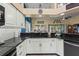 Eat-in kitchen with a breakfast bar, granite countertops, and white cabinets at 1400 Summerwood Ct, Spring Hill, FL 34606