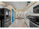 Bright kitchen with white cabinets, black appliances and breakfast nook at 1400 Summerwood Ct, Spring Hill, FL 34606