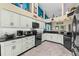 Spacious kitchen with white cabinets, black appliances, and granite countertops at 1400 Summerwood Ct, Spring Hill, FL 34606
