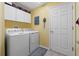 Laundry room with washer, dryer, and ample cabinet storage at 1400 Summerwood Ct, Spring Hill, FL 34606