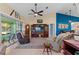 Relaxing living room with hardwood floors, comfortable seating, and large windows at 1400 Summerwood Ct, Spring Hill, FL 34606
