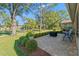 Inviting patio with pavers, landscaping, and ample space for outdoor furniture at 1400 Summerwood Ct, Spring Hill, FL 34606