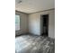 Bright bedroom with wood-look flooring and a window at 1925 Patriot Ln, Holiday, FL 34690