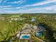 Community pool, tennis, pickleball courts, and clubhouse are featured in this aerial view at 19907 Tattnall Way, Brooksville, FL 34601