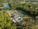 Aerial view showing community pool, tennis, pickleball courts, and clubhouse at 19907 Tattnall Way, Brooksville, FL 34601
