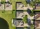 Aerial view of houses near a lake in a residential area at 19907 Tattnall Way, Brooksville, FL 34601