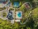 Community pool, tennis and pickleball courts, and clubhouse with surrounding green space at 19907 Tattnall Way, Brooksville, FL 34601