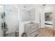 Spa-like bathroom with marble finishes, a walk-in shower, and plenty of storage at 19907 Tattnall Way, Brooksville, FL 34601