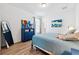 Bright bedroom with blue dresser and large bed at 19907 Tattnall Way, Brooksville, FL 34601