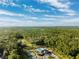 Aerial view of community pool, tennis courts, and clubhouse at 19907 Tattnall Way, Brooksville, FL 34601
