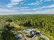 Aerial view of community pool, tennis courts, and clubhouse at 19907 Tattnall Way, Brooksville, FL 34601
