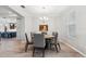 Round dining table with six chairs and view into kitchen at 19907 Tattnall Way, Brooksville, FL 34601
