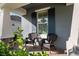 Relaxing front porch with wicker chairs and a pumpkin for the season at 19907 Tattnall Way, Brooksville, FL 34601